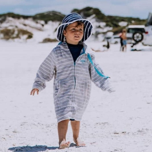 Boy wearing zip up swim robe and swoodi UPF50+ beach bucket hat at Esperance beach