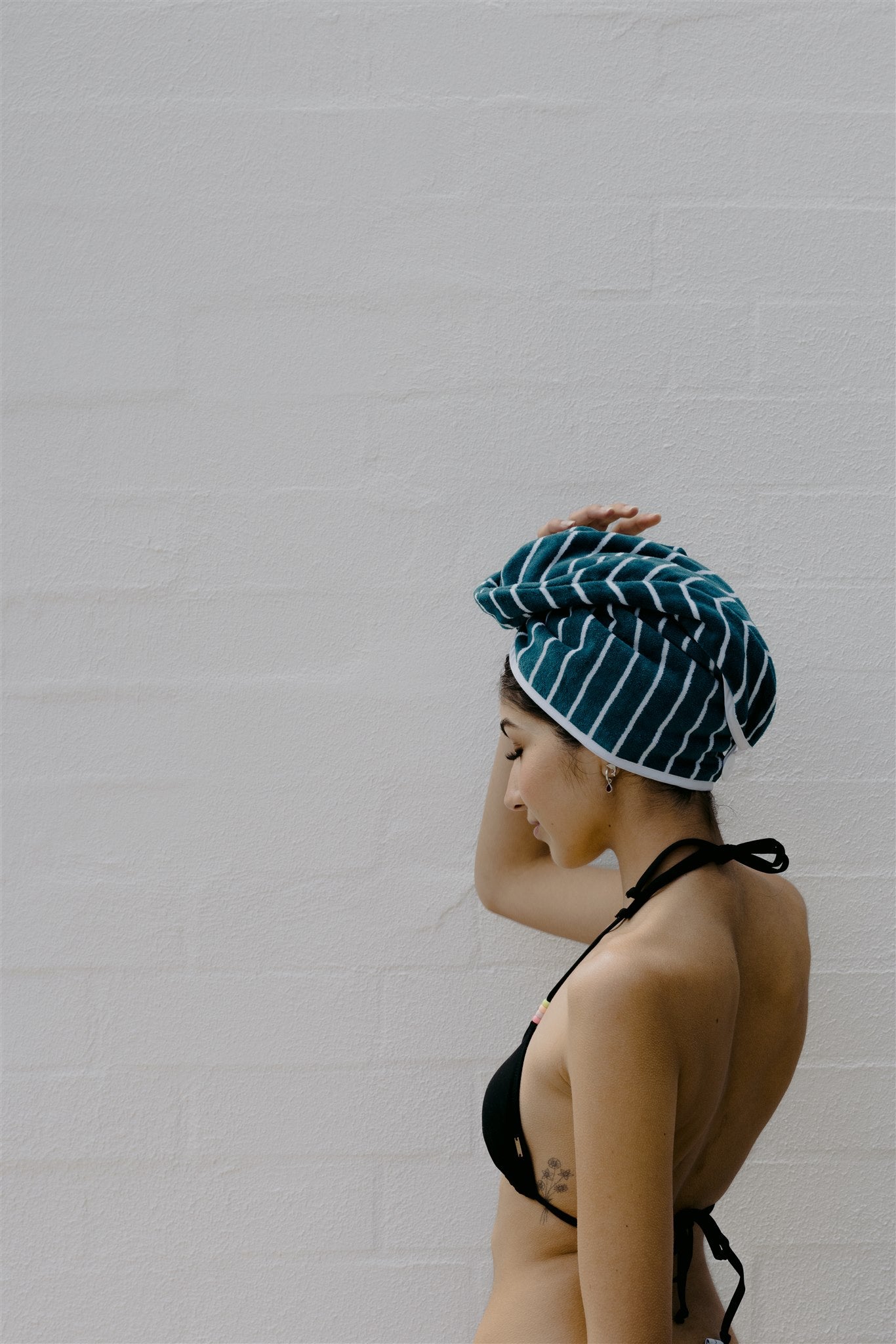 Back view of female model wearing swoodi hair wrap in turquoise