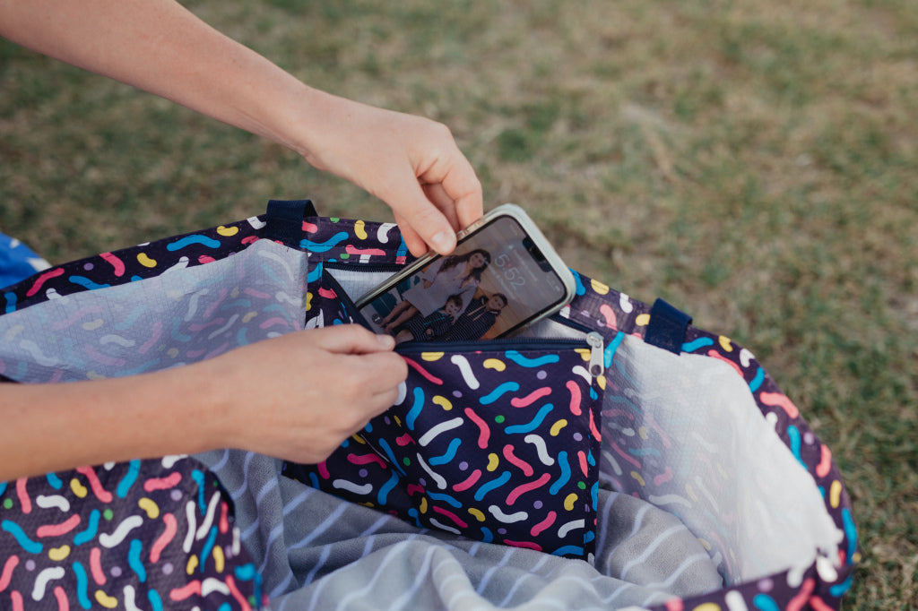 Putting  phone into water proof beach bag zip up pocket 