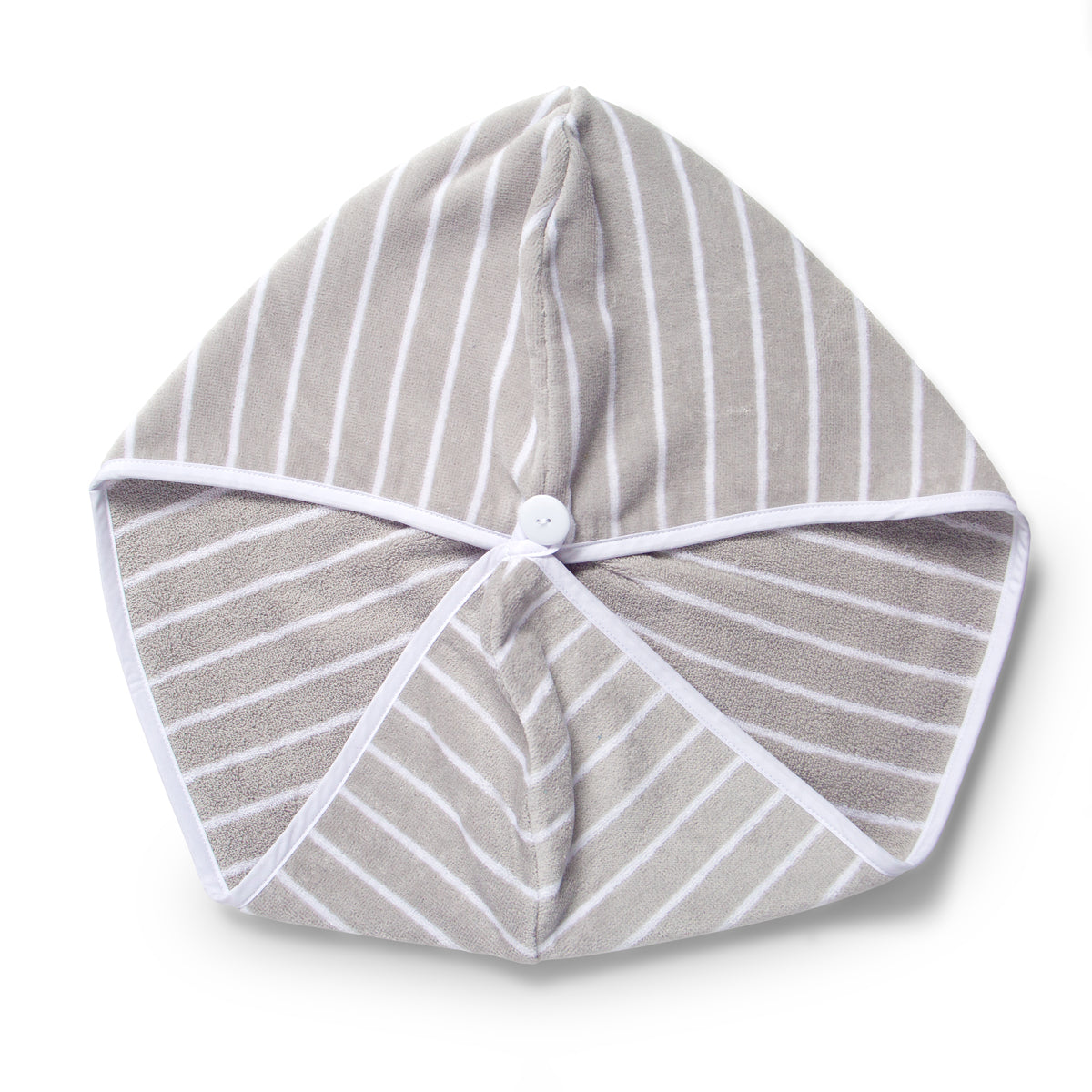 Flat lay of grey and white stripe hair towel with white button 